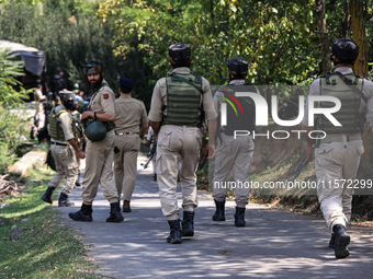 Indian Army, JK Police, and CRPF personnel rush towards the site where an encounter breaks out between security forces and militants at Chec...