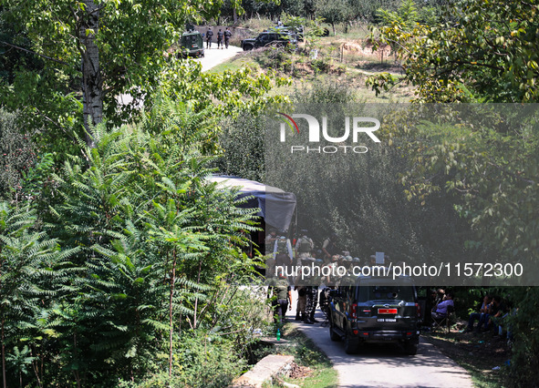 Indian Army, JK Police, and CRPF personnel rush towards the site where an encounter breaks out between security forces and militants at Chec...