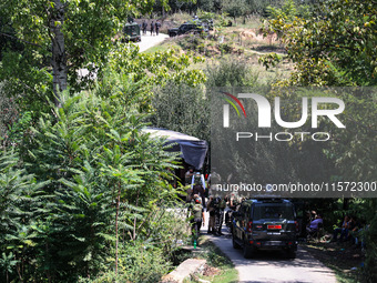 Indian Army, JK Police, and CRPF personnel rush towards the site where an encounter breaks out between security forces and militants at Chec...