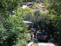 Indian Army, JK Police, and CRPF personnel rush towards the site where an encounter breaks out between security forces and militants at Chec...