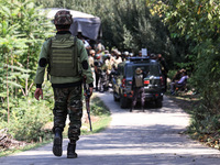 Indian Army, JK Police, and CRPF personnel rush towards the site where an encounter breaks out between security forces and militants at Chec...