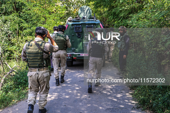 Indian Army, JK Police, and CRPF personnel rush towards the site where an encounter breaks out between security forces and militants at Chec...