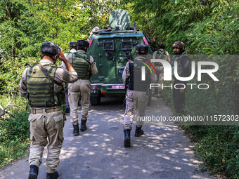 Indian Army, JK Police, and CRPF personnel rush towards the site where an encounter breaks out between security forces and militants at Chec...