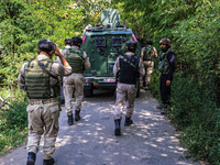 Indian Army, JK Police, and CRPF personnel rush towards the site where an encounter breaks out between security forces and militants at Chec...