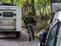 Indian Army, JK Police, and CRPF personnel rush towards the site where an encounter breaks out between security forces and militants at Chec...