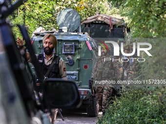 Indian Army, JK Police, and CRPF personnel rush towards the site where an encounter breaks out between security forces and militants at Chec...