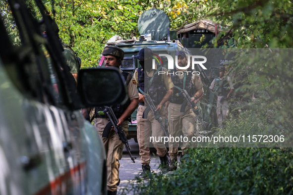 Indian Army, JK Police, and CRPF personnel rush towards the site where an encounter breaks out between security forces and militants at Chec...