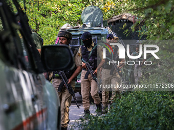 Indian Army, JK Police, and CRPF personnel rush towards the site where an encounter breaks out between security forces and militants at Chec...