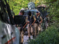 Indian Army, JK Police, and CRPF personnel rush towards the site where an encounter breaks out between security forces and militants at Chec...