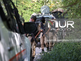 Indian Army, JK Police, and CRPF personnel rush towards the site where an encounter breaks out between security forces and militants at Chec...