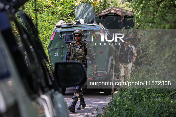 Indian Army, JK Police, and CRPF personnel rush towards the site where an encounter breaks out between security forces and militants at Chec...