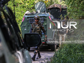 Indian Army, JK Police, and CRPF personnel rush towards the site where an encounter breaks out between security forces and militants at Chec...