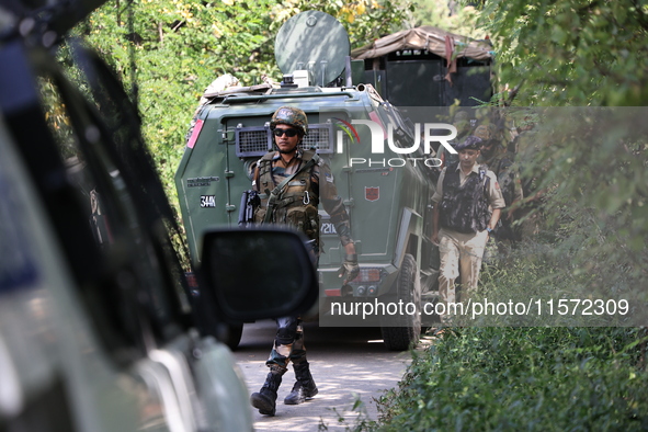 Indian Army, JK Police, and CRPF personnel rush towards the site where an encounter breaks out between security forces and militants at Chec...