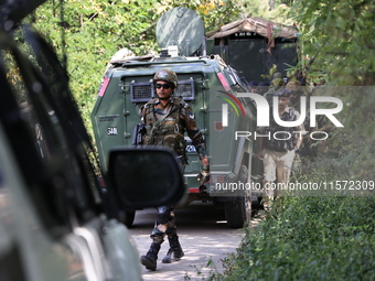 Indian Army, JK Police, and CRPF personnel rush towards the site where an encounter breaks out between security forces and militants at Chec...