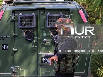 Indian Army, JK Police, and CRPF personnel rush towards the site where an encounter breaks out between security forces and militants at Chec...