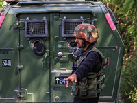 Indian Army, JK Police, and CRPF personnel rush towards the site where an encounter breaks out between security forces and militants at Chec...