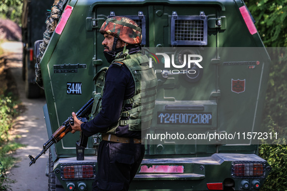 Indian Army, JK Police, and CRPF personnel rush towards the site where an encounter breaks out between security forces and militants at Chec...