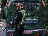 Indian Army, JK Police, and CRPF personnel rush towards the site where an encounter breaks out between security forces and militants at Chec...