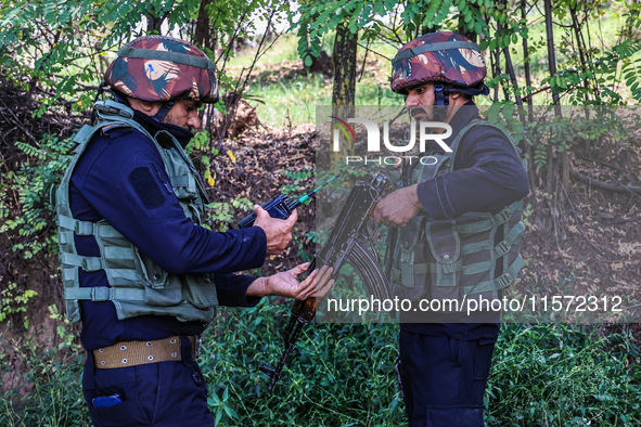 Indian Army, JK Police, and CRPF personnel rush towards the site where an encounter breaks out between security forces and militants at Chec...