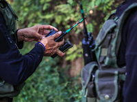 Army soldiers replace batteries of wireless sets as Indian Army, Jk Police, and CRPF personnel rush towards the site where an encounter brea...