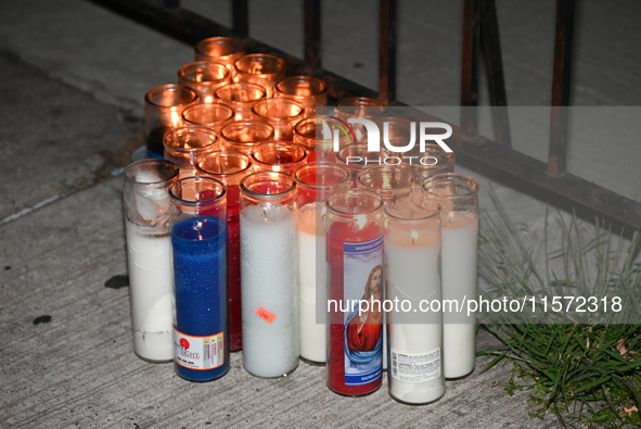 A makeshift memorial stands at the scene of candles. Police shoot and kill a man who flashes a knife at them at an apartment in Flatbush, Br...