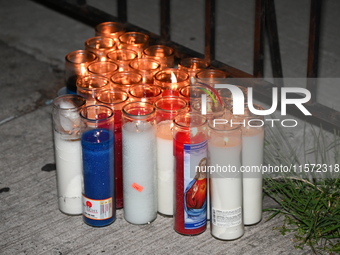 A makeshift memorial stands at the scene of candles. Police shoot and kill a man who flashes a knife at them at an apartment in Flatbush, Br...