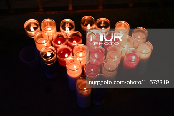 Makeshift memorial candles are at the scene. Police shoot and kill a man who flashes a knife at them at an apartment in Flatbush, Brooklyn,...