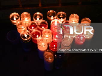 Makeshift memorial candles are at the scene. Police shoot and kill a man who flashes a knife at them at an apartment in Flatbush, Brooklyn,...