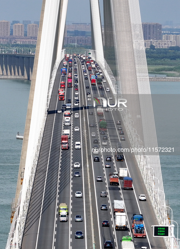 Vehicles travel on the Shanghai-Suzhou-Nantong Yangtze River Bridge in Suzhou, China, on September 14, 2024. 