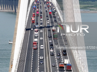 Vehicles travel on the Shanghai-Suzhou-Nantong Yangtze River Bridge in Suzhou, China, on September 14, 2024. (