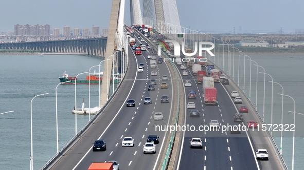 Vehicles travel on the Shanghai-Suzhou-Nantong Yangtze River Bridge in Suzhou, China, on September 14, 2024. 