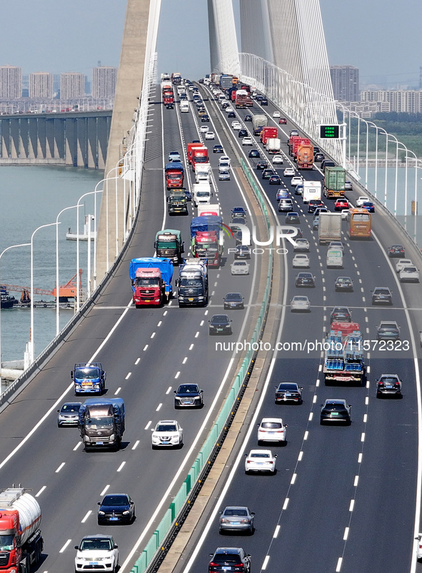 Vehicles travel on the Shanghai-Suzhou-Nantong Yangtze River Bridge in Suzhou, China, on September 14, 2024. 