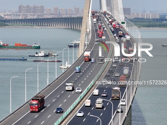 Vehicles travel on the Shanghai-Suzhou-Nantong Yangtze River Bridge in Suzhou, China, on September 14, 2024. (