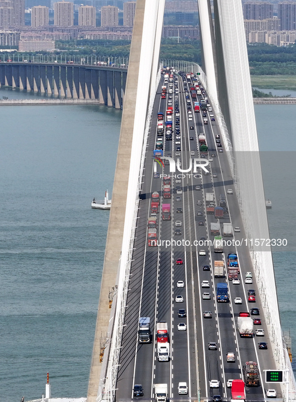 Vehicles travel on the Shanghai-Suzhou-Nantong Yangtze River Bridge in Suzhou, China, on September 14, 2024. 