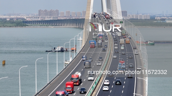 Vehicles travel on the Shanghai-Suzhou-Nantong Yangtze River Bridge in Suzhou, China, on September 14, 2024. 