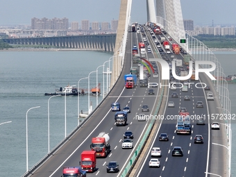 Vehicles travel on the Shanghai-Suzhou-Nantong Yangtze River Bridge in Suzhou, China, on September 14, 2024. (