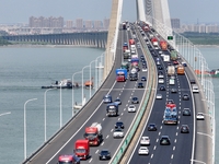 Vehicles travel on the Shanghai-Suzhou-Nantong Yangtze River Bridge in Suzhou, China, on September 14, 2024. (