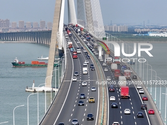 Vehicles travel on the Shanghai-Suzhou-Nantong Yangtze River Bridge in Suzhou, China, on September 14, 2024. (