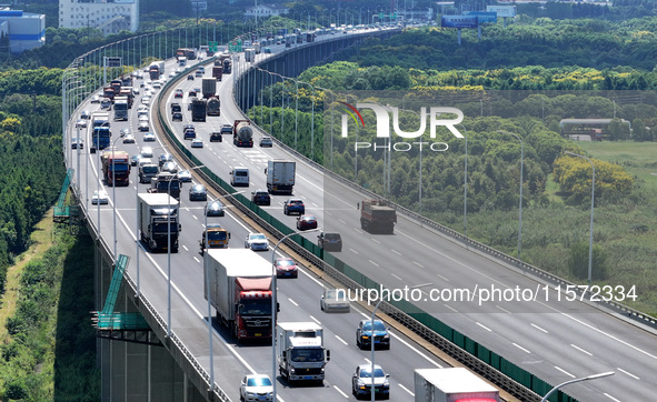 Vehicles travel on the Shanghai-Suzhou-Nantong Yangtze River Bridge in Suzhou, China, on September 14, 2024. 