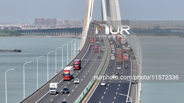 Vehicles travel on the Shanghai-Suzhou-Nantong Yangtze River Bridge in Suzhou, China, on September 14, 2024. 