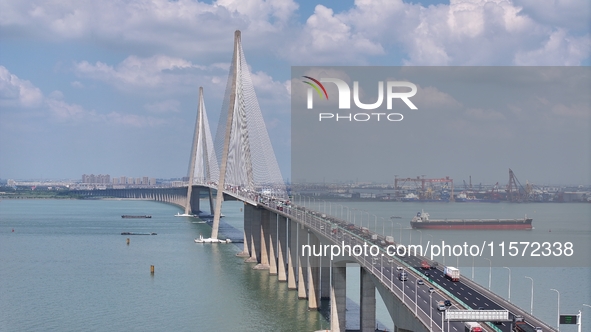 Vehicles travel on the Shanghai-Suzhou-Nantong Yangtze River Bridge in Suzhou, China, on September 14, 2024. 