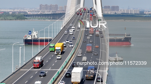 Vehicles travel on the Shanghai-Suzhou-Nantong Yangtze River Bridge in Suzhou, China, on September 14, 2024. 