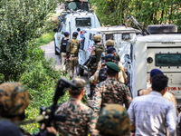 Indian security officials move towards an encounter site between militants and security forces in Check Kreeri Tapper in Baramulla, Jammu an...