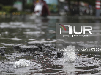 People travel in the rain in Huai'an, China, on September 14, 2024. (