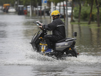 People travel in the rain in Huai'an, China, on September 14, 2024. (