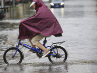 People travel in the rain in Huai'an, China, on September 14, 2024. (