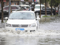 People travel in the rain in Huai'an, China, on September 14, 2024. (