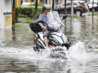 People travel in the rain in Huai'an, China, on September 14, 2024. (