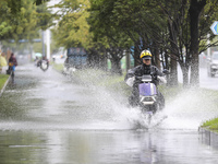 People travel in the rain in Huai'an, China, on September 14, 2024. (