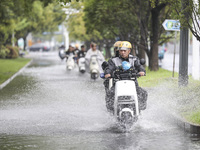 People travel in the rain in Huai'an, China, on September 14, 2024. (